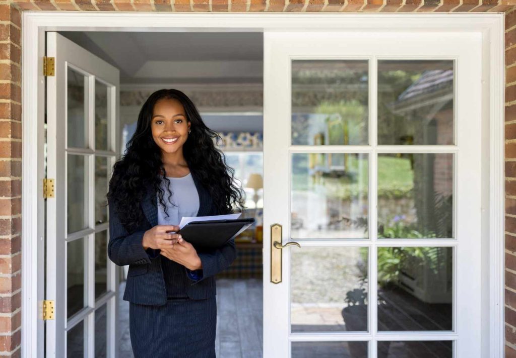 Property management professional welcoming clients at the entrance of a rental property